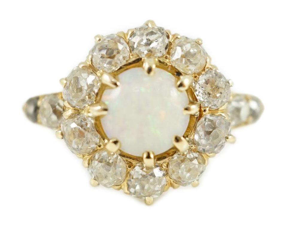 An early 20th century gold, white opal and diamond set circular cluster ring